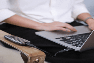 A sleek, modern external SSD connected to a laptop's USB port, illustrating how to use an external SSD as a boot drive for a major performance upgrade.