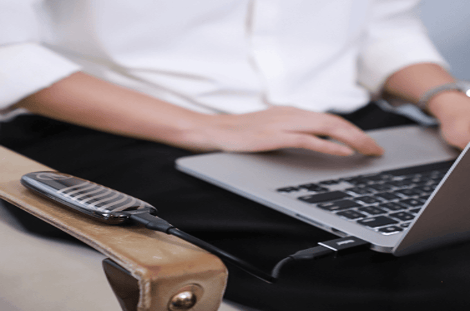 A sleek, modern external SSD connected to a laptop's USB port, illustrating how to use an external SSD as a boot drive for a major performance upgrade.