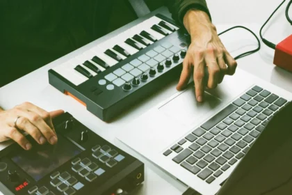 Samsung T7 Shield portable SSD sitting on a studio desk next to a laptop running a DAW (Drives)