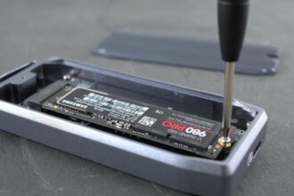 An external SSD connected to a laptop with a USB cable.